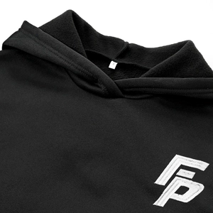 Close-up of black fleece hoodie with white embroidered logo and stitched neck size label