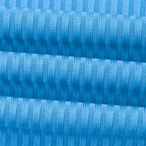 Macro detail of sky blue ribbed knit fabric showing soft texture and vertical patterns