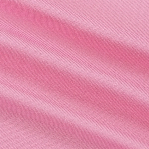 Close-up macro view of pink knitted fabric texture showing elastic weave structure
