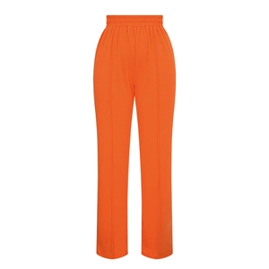 Detail of bright orange high-waisted wide-leg pants with vertical seam stitching