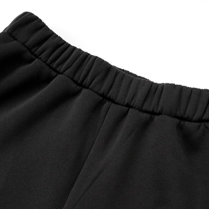 Detailed macro view of the elastic waistband on black sports jogger pants