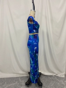 Detail shot of the blue tie-dye marble print pattern and side ruching on the slim maxi skirt