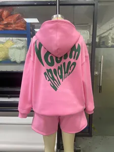 Close-up of pink long-sleeve hoodie with green heart-shaped graphic on back
