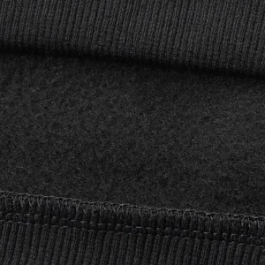 Detail shot of the black hoodie featuring ribbed cuffs and warm fleece lining texture