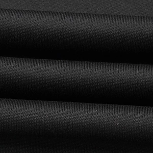Macro shot of high-quality black knitted fabric texture with soft flexible folds