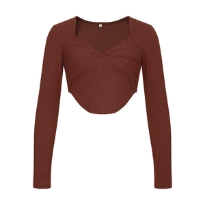 Detail of dark brown ribbed knit crop top with twist front and curved hem design