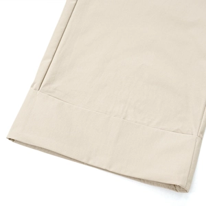 Detailed view of beige wide-leg pants featuring premium woven fabric and precision stitching
