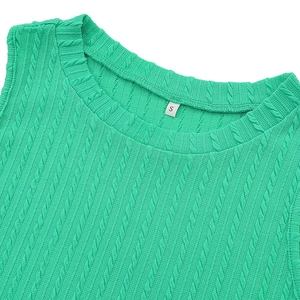 Detailed macro view of vibrant green cable knit fabric and neckline with size S label