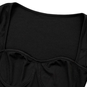 Close-up of black ribbed fabric top featuring square neckline and bust seam detail