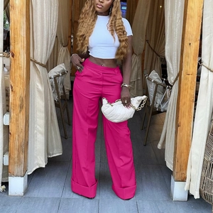 Chic women's hot pink high-waisted wide-leg trousers paired with a white crop top