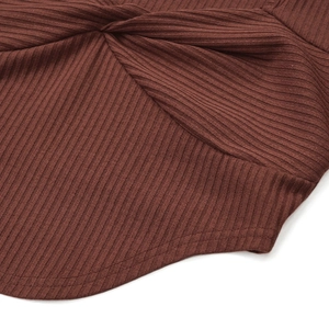 Detail of dark brown ribbed knit fabric featuring a twist design and curved hemline