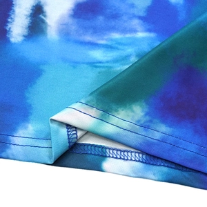 Detail of blue tie-dye fabric showing elastic texture and double-needle stitching quality