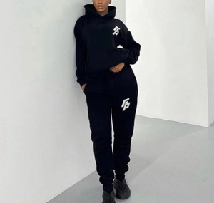 Close-up of black hooded sweatshirt with white FP logo and matching joggers set