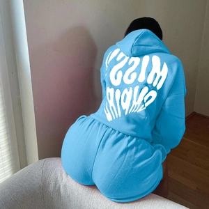 Detail view of bright blue hoodie and shorts set with white Missy Empire logo on back