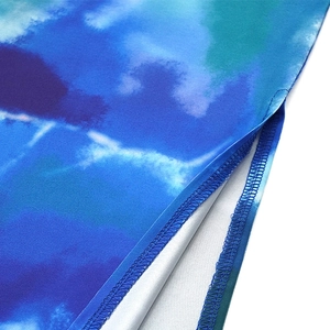 Detail view showing tie-dye watercolor print fabric and side slit stitching on the skirt