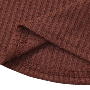 Detailed macro view of the ribbed knit fabric texture and high-quality hem stitching