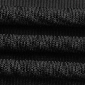 Macro detail of high-quality black ribbed knit fabric with vertical textured structure