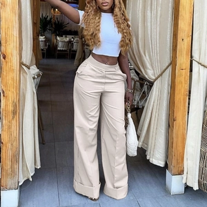 Detail of high waisted wide leg trousers in beige with stylish wide folded cuffs