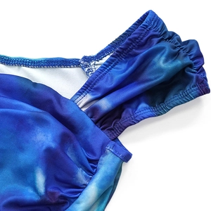 Detailed view of blue tie-dye cropped top showing ruching process and stitching texture