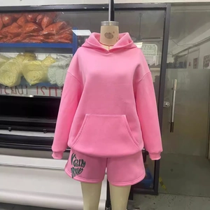 Pink lounge set with a long sleeve hooded sweatshirt and matching logo shorts
