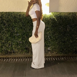 Women's white two-piece set featuring crop top and wide-leg trousers for casual style