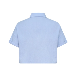 Back view of light blue short sleeve shirt showing natural fiber texture and cuffed sleeves