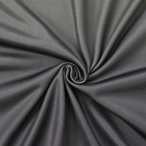 Macro shot of dark charcoal grey fabric with a smooth sheen and fine twill texture