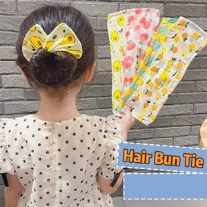 Detail of children hair bun maker with colorful fruit prints and large bow design