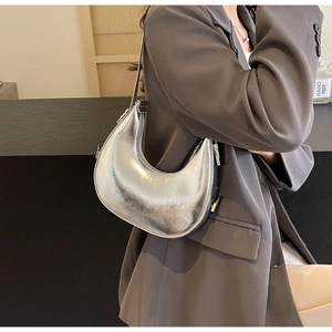 Mirror silver hobo bag styled with a grey suit for a minimalist professional commute look
