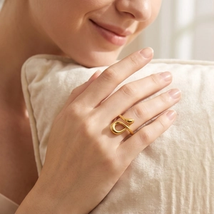 Minimalist gold musical note stainless steel ring on model hand with luxury design