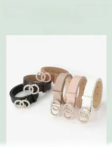 Detail of five assorted leather belts featuring sparkling double-ring rhinestone buckles