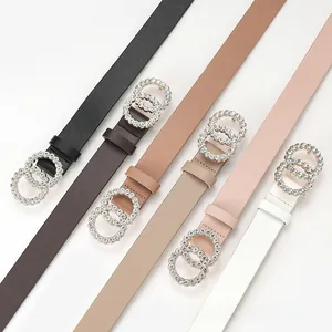 Detail of thin faux leather belts for women with rhinestone-encrusted double ring buckles