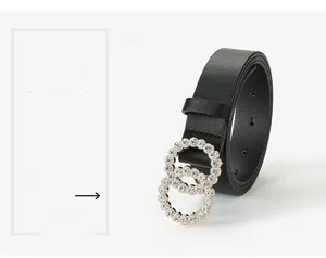 Detail of elegant black belt with sparkling rose gold rhinestone-studded double ring buckle