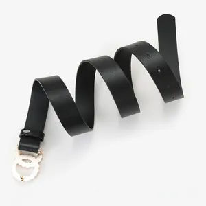 Detail of black leather belt with double interlocking gold rings and rippled edge finish