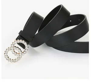 Detail of black leather belt featuring sparkling double ring buckle with rhinestones