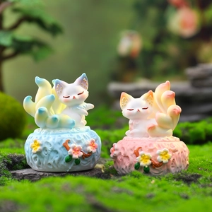 Set of blue and pink Kunlun nine-tailed fox resin figurines on floral base pedestals