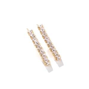 Detail of linear gold earrings with nine square-cut cubic zirconia in a prong setting
