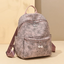 Detail view of pink and grey marble pattern texture on a large capacity laptop backpack