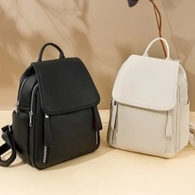 Front view of black and beige PU leather backpacks with dual vertical zipper details