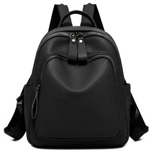 Detailed view of large capacity black leather backpack with litchi grain texture