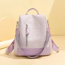 Detail view of the lavender backpack's textured fabric and vertical silver zipper design