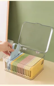 Macro detail of acrylic storage box with flip lid showing organized silicone phone cases
