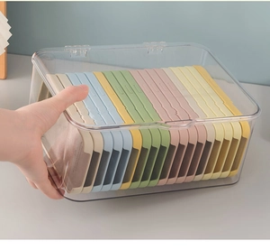 Close-up of high-transparency acrylic organizer box with flip-lid and colorful phone cases