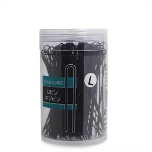 Macro detail of black U-shaped hairpins stored in a transparent cylinder container