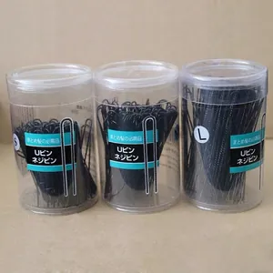 Three sizes of black U-shaped metal hairpins in cylindrical bottles for hair styling