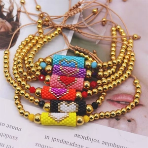 Handmade Miyuki bead bracelet with golden steel balls and heart pattern charms
