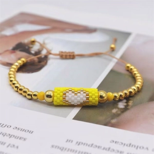 Handmade Miyuki bead bracelet with golden beads and white heart motif charm