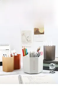 Multi-slot hexagonal desk organizer for stationery in various colors on a modern office desk