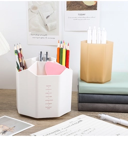 Macro view of a white multi-compartment hexagonal pencil holder with matte finish