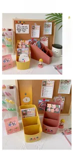 Close-up of tiered cartoon desktop organizers in soft yellow and pink with stickers